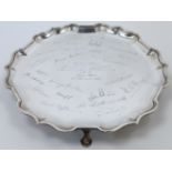 An Edwardian silver salver, London, 1910, Mappin & Webb, of circular form with scalloped rim, rai...