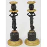 A pair of French bronze and ormolu figural candlesticks, 19th century, each with acanthus leaf sc...