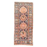 A Caucasian long rug, second quarter 20th century, the central field with four medallions, on a c...