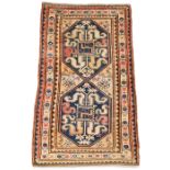 A Caucasian Kazak rug, second quarter 20th century, the central field with two geometric medallio...