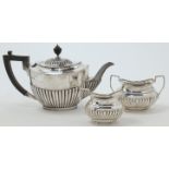 A silver teapot, Sheffield, 1917, date and makers mark rubbed, with presentation engraving and ha...