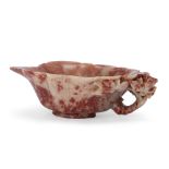 A Chinese soapstone cup, Qing dynasty, 19th century, formed as a large leaf, carved with flowerin...