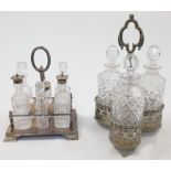 Three cut-glass decanters and stoppers, in a silver plated stand, with pierced foliate border and...