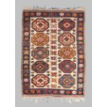 A Turkish Kozak rug, last quarter 20th century, the central field with ten geometric medallions, ...