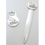 A Christofle silver plated paper knife and bottle opener, 22cm high - paper knife, 7.9cm high - b...