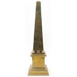 A hollow brass obelisk, 20th century, of gently tapering form, the column raised on ball feet abo...