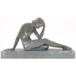 An Art Deco style painted plaster study of a seated nude female, 20th century, modelled with her ...