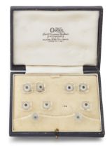 A white gold rock crystal quartz and sapphire dress set, comprising: a pair of cufflinks designed...