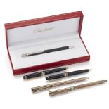 A group of five ballpoint pens, comprising: a Cartier Must II example, numbered 00253, with box a...