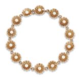 Cropp & Farr. A 9ct gold seed pearl bracelet, the links of flowerhead design each set with a sing...