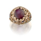 A star ruby single stone bombé ring, the single star ruby claw-set in a raised pierced foliate be...