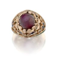 A star ruby single stone bombé ring, the single star ruby claw-set in a raised pierced foliate be...