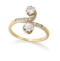 An Edwardian gold diamond crossover ring, two claw-set old European cut diamonds, to scrolling cr...