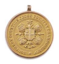 A 9ct gold running medal, Southern Counties Cross Country Championship, engraved 'Highgate H 1st ...