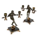 A pair of French gilt and patinated bronze figural twin-light candelabra, after the model by Emil...