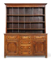 A George III oak dresser, last quarter 18th century, the plate rack back above six drawers and tw...