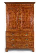A George III mahogany linen press, last quarter 18th century, the stepped cornice with dentil mou...