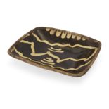 A Staffordshire slipware dish, 18th century, of rounded rectangular shape with plain edge, decora...