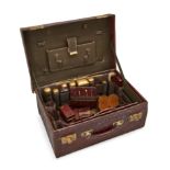 A late Victorian crocodile skin vanity case, the partially fitted interior with removeable compar...
