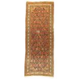 A Persian Malayer long rug, last quarter 19th century, the central field with repeating flower he...