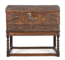 An English painted leather clad dome top chest, last quarter 17th century, brass stud bound, pain...