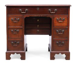 A George III mahogany kneehole desk, last quarter 18th century, the top with ogee edge, above an ...