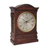 A Victorian rosewood bracket clock, mid-19th century, with shaped top above applied honeysuckle c...