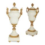 A pair of gilt-bronze mounted white marble urns and covers, second half 20th century, with berrie...