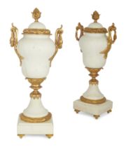 A pair of gilt-bronze mounted white marble urns and covers, second half 20th century, with berrie...