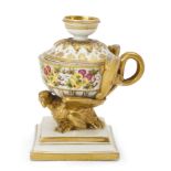 An English porcelain inkwell, c.1820, supported on a gilt eagle, the inkwell painted with panels ...