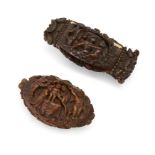 Two French carved coquilla nut snuff boxes, early 19th century, the hinged cover of one carved wi...