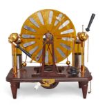 A Wimshurst electrostatic machine, second half 20th century, on a mahogany base bearing plaque in...