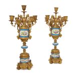 A pair of French gilt-bronze mounted Sèvres-style porcelain five-light candelabra