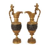 A pair of French gilt and patinated bronze ewers, in the manner of Clodion, late 19th century, ca...