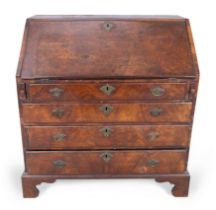 A George II walnut and mahogany bureau, second quarter 18th century, the fall front enclosing fit...