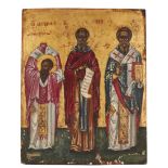 A Greek icon of Three Saints, early 20th century, the saints portrayed frontally full-length with...