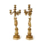 A pair of French gilt-bronze five light candelabra, late 19th century, each with fluted and folia...