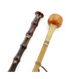 A gilt-metal-mounted faux amber walking cane, early 20th century, with a colourless faceted paste...