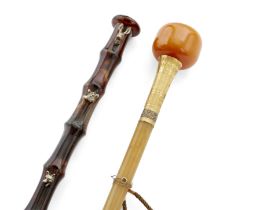 A gilt-metal-mounted faux amber walking cane, early 20th century, with a colourless faceted paste...