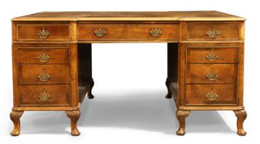 An English walnut inverted breakfront partners desk, Queen Anne style, first quarter 20th century...