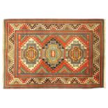 A Kazak rug, third quarter 20th century, the central field with three geometric medallions, on a ...