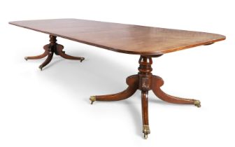 An English mahogany twin pedestal extending dining table, of Regency style, 20th century, the rou...