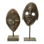 A Dan racing mask, Côte d'Ivoire, with plaited fibre coiffure and metal inlay around pierced circ...