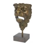 A Continental bronze lion mask, 18th/19th century, possibly a furniture mount, on later stand, 22...
