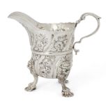 An Irish silver cream jug, Dublin, c.1740, probably Samuel Walker, raised on four paw feet with l...