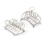 Two George III six division silver toast racks, the larger example with arched base raised on fou...