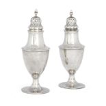 A pair of George II silver casters by Hester Bateman, London, 1788, with baluster shaped bodies a...