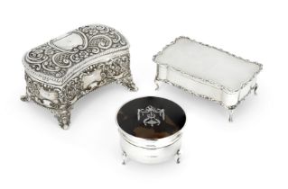 Three silver jewellery/sewing boxes, comprising: a shaped Edwardian example, Birmingham, 1906, Wi...