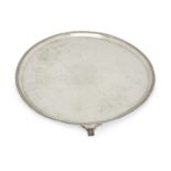 A large George III silver salver, London, 1790, John Hutson, with beaded border and raised on fou...