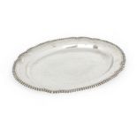 A George III silver meat platter, London, 1800, John Mewburn, of shaped oval form with gadrooned ...